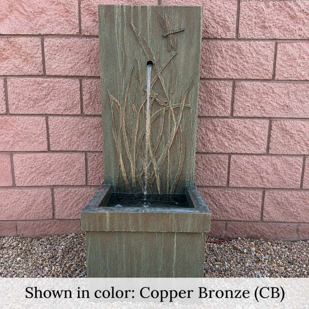 Dragonfly Wall Fountain n gravel against bricks wall