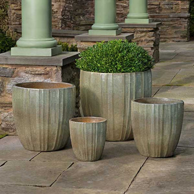 Dunes Planter - Crystal Green - S/4 on concrete filled with plants