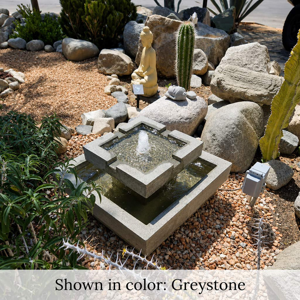 Escala Fountain on pebbles in action.