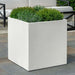 Farnley Planter 2424 S/1 in chalk lite on concrete filled with plants.