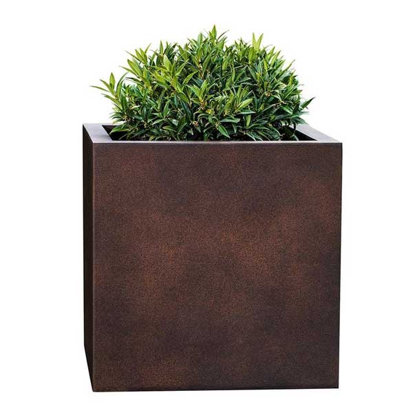 Farnley Planter 2424 S/1 in rust lite filled with plants against white background.