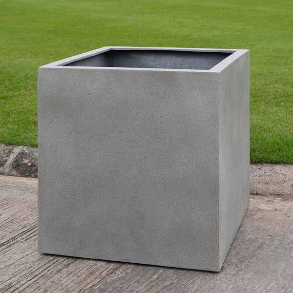 Farnley Planter 2424 S/1 in stone grey lite on concrete in the backyard.