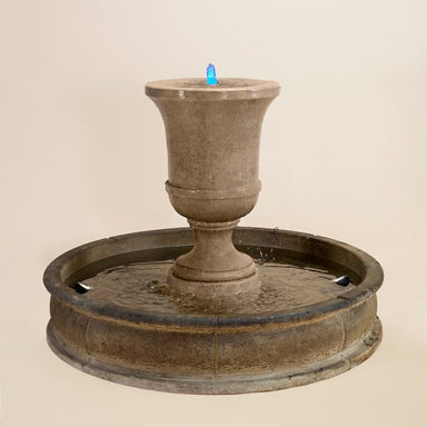 Fascea Urna Fountain against brown background.