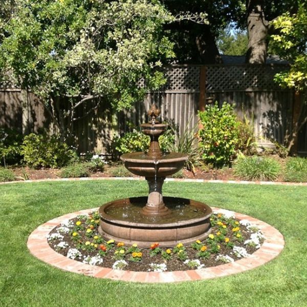Fleur de Lis Pond Fountain in action in the garden. 