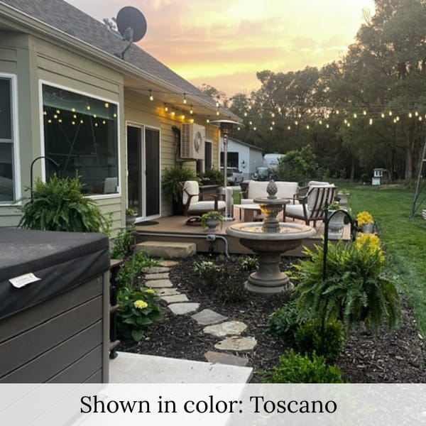 Close-up view of the Fontana Grande fountain glowing at sunset in a peaceful backyard setting.