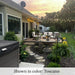 Close-up view of the Fontana Grande fountain glowing at sunset in a peaceful backyard setting.
