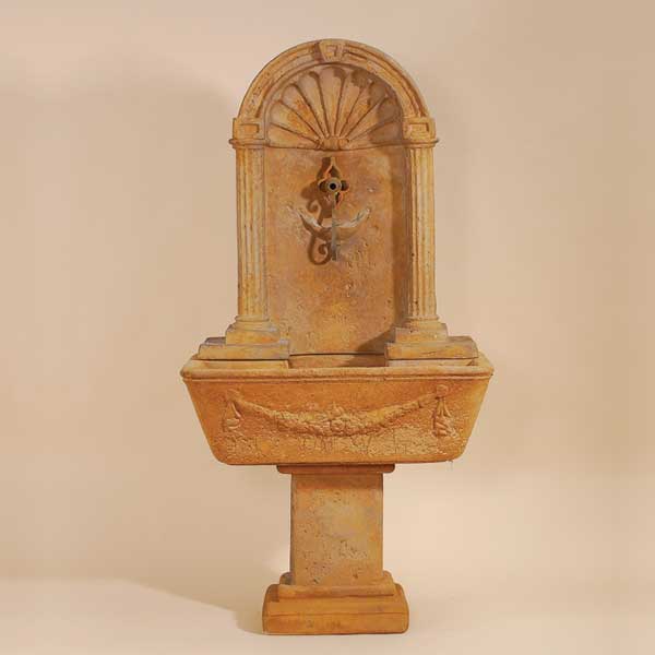 Foritalico Wall Fountain for Spout against brown background.