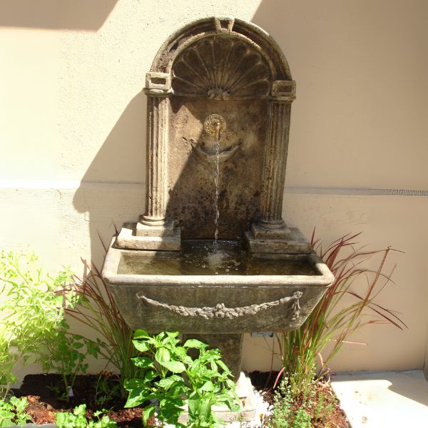 Foritalico Wall Fountain for spout in action against cream wall.