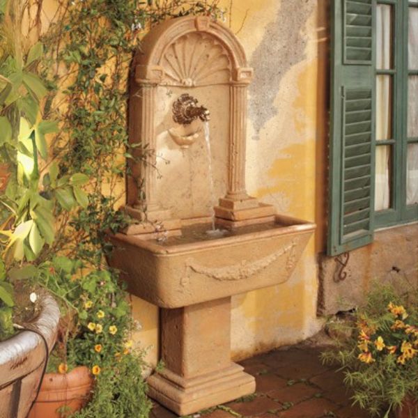 Foritalico Wall Fountain for spout in action beside the house window.