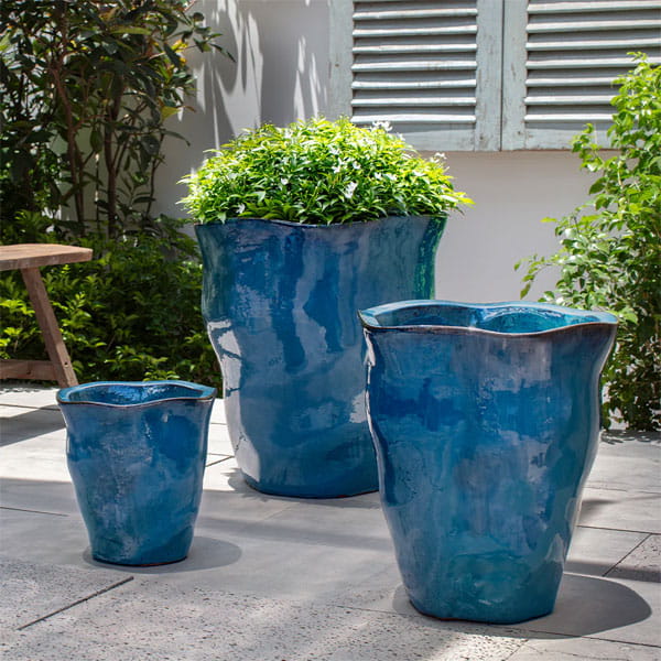 Foxglove Planter - Mediterranean - on concrete filled with plants.