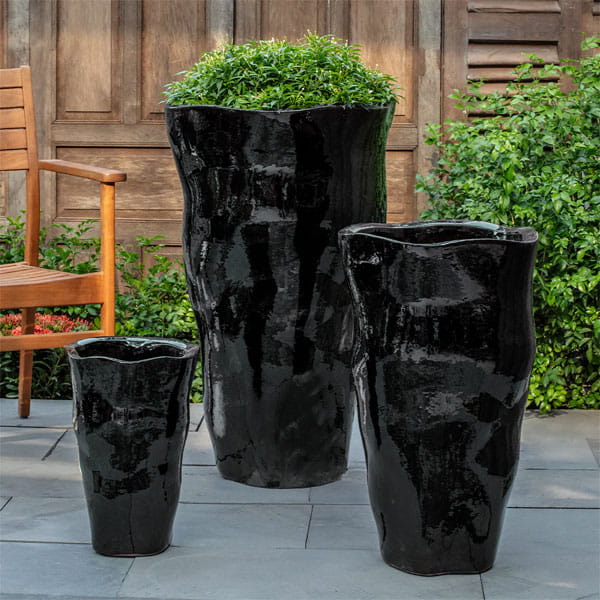 Foxglove Planter, Tall in Obsidian on concrete in the backyard