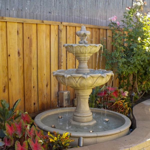 Gardenia Two Tier Pond Fountain against wooden fence in action.