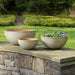 Glenside Bowl Planter - Cream - S/3 filled with purple flowers in the backyard