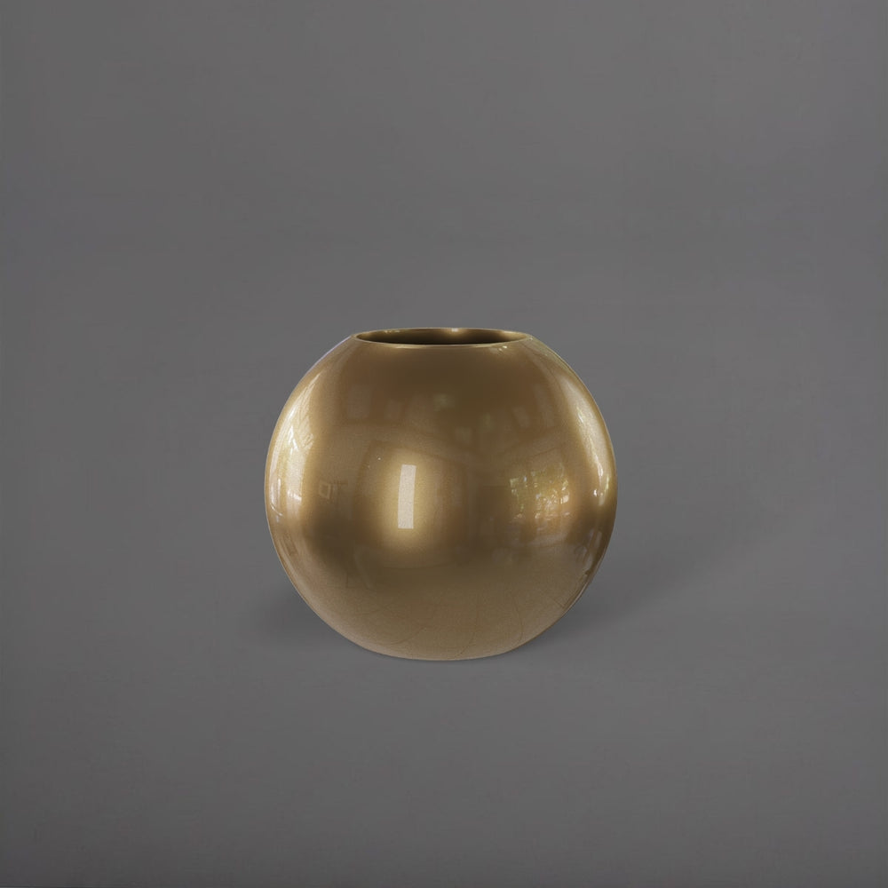 Globe Fiberglass Planter in gloss metallic gold against gray background.