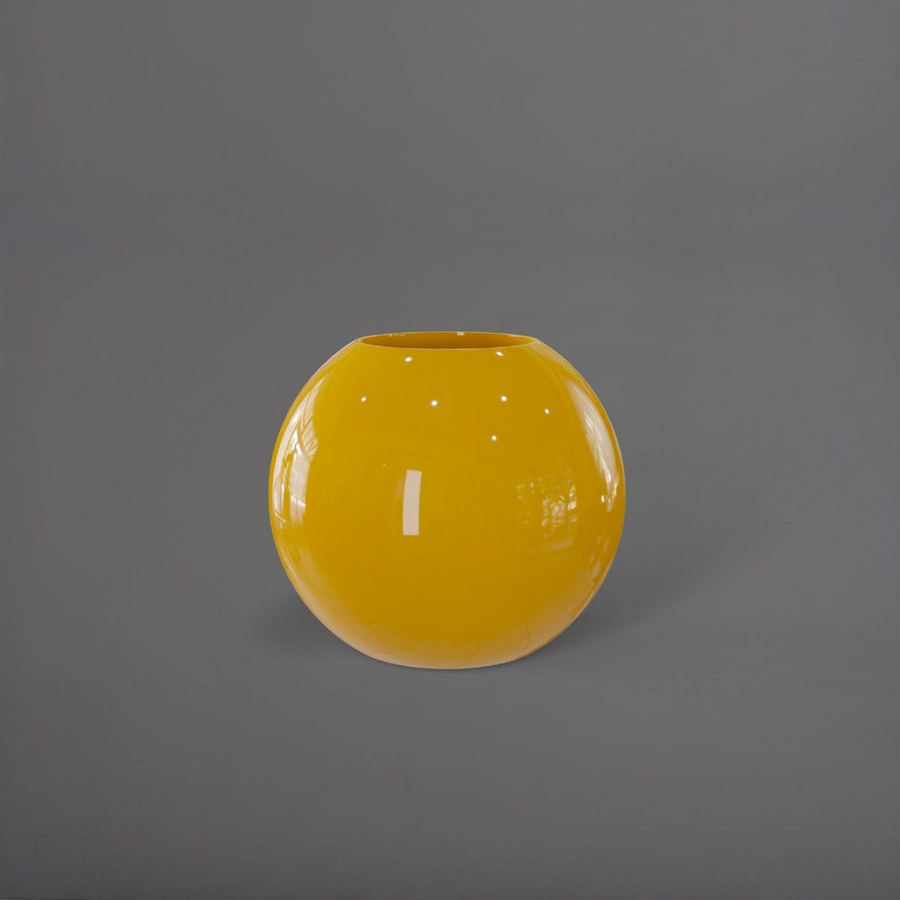 Globe Fiberglass Planter in gloss saffron against gray background.