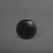 Globe Fiberglass Planter in matte black against gray background.