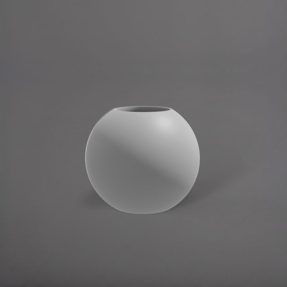 Globe Fiberglass Planter in matte cement grey against gray background.