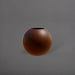 Globe Fiberglass Planter in matte dark brown against gray background.