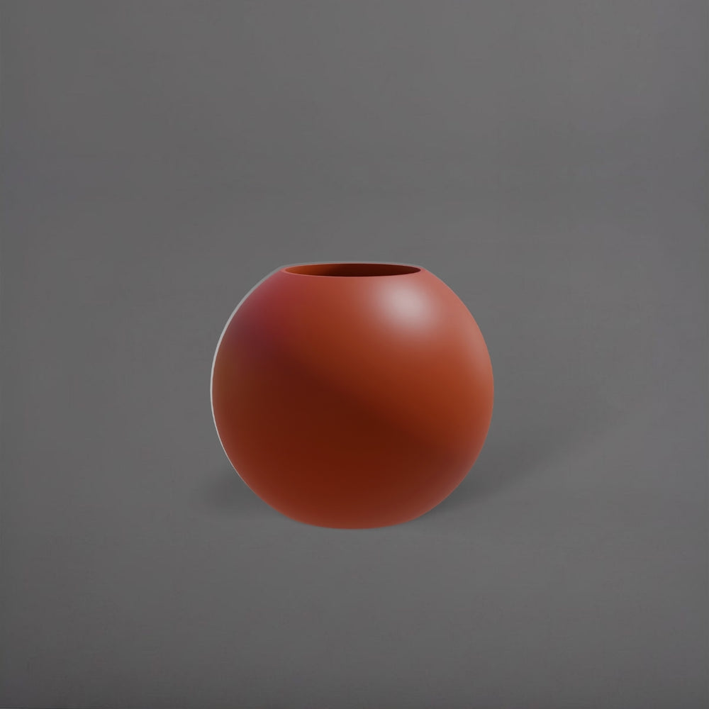 Globe Fiberglass Planter in matte terra cotta against gray background.