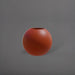 Globe Fiberglass Planter in matte terra cotta against gray background.