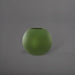 Globe Fiberglass Planter in satin green against gray background.