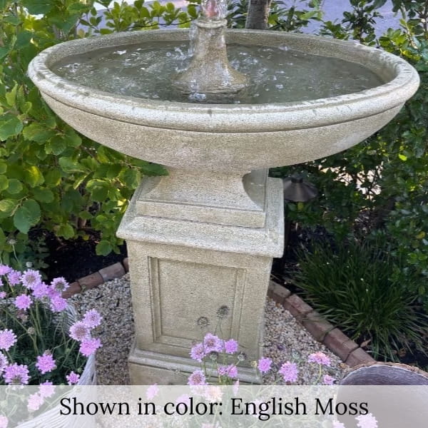 Gramercy Fountain in action beside purple flowers.
