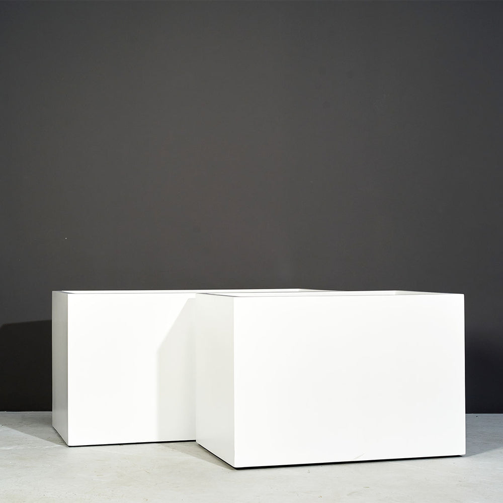 Granada Wide Rectangle Fiberglass Planter on concrete shown with different sizes.