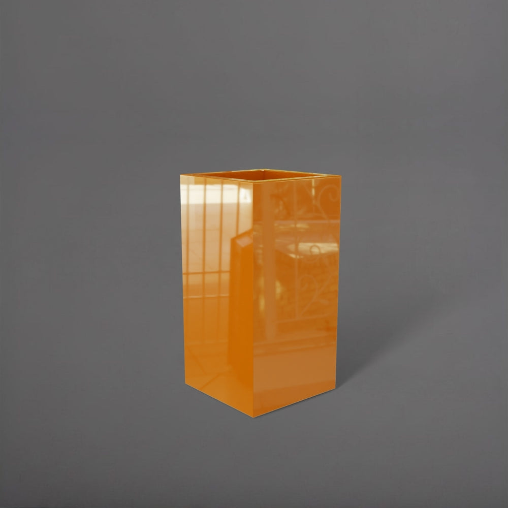 Hollywood Corner Fiberglass Planter in gloss tangerine against gray background.