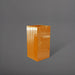 Hollywood Corner Fiberglass Planter in gloss tangerine against gray background.