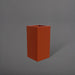 Hollywood Corner Fiberglass Planter in matte terra cotta against gray background.