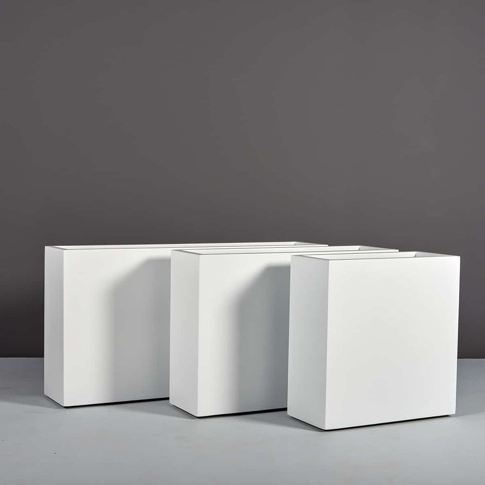 Hollywood Rectangle Fiberglass Planter on concrete shown in different sizes.