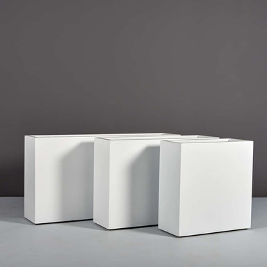 Hollywood Rectangle Fiberglass Planter on concrete shown in different sizes.