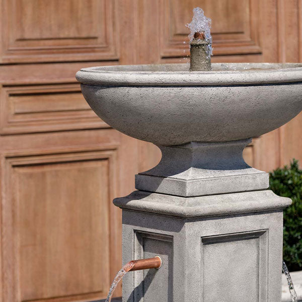 La Riviere Fountain on gravel in the backyard upclose