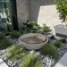 Large Girona modern outdoor water fountain with concrete bowl design in backyard rock garden.