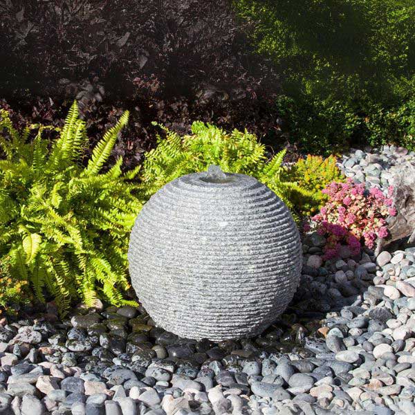 Large Ribbed Sphere Granite Fountain Kit in action in the backyard