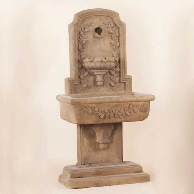 Lemon Lavabo Wall Fountain against brown background.