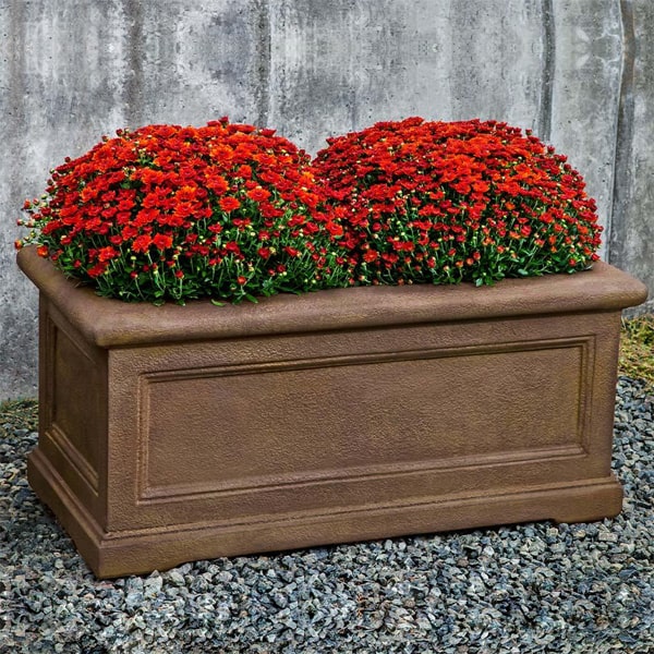 Lenotre Rectangle 482424 planter on gravel filled with red flowers