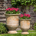 Lipari Urn Antico Terra Cotta S/2 on grass in the backyard.