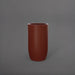 Lisbon Tall Round Tapered Fiberglass Planter in matte terra cotta against gray background.
