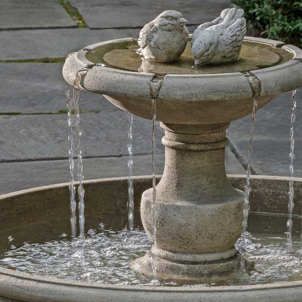 Lucienne Fountain on concrete with plants background upclose