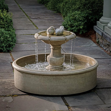 Lucienne Fountain on concrete with plants background.