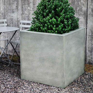 Metropolis Cube 3030 Planter on gravel filled with plants