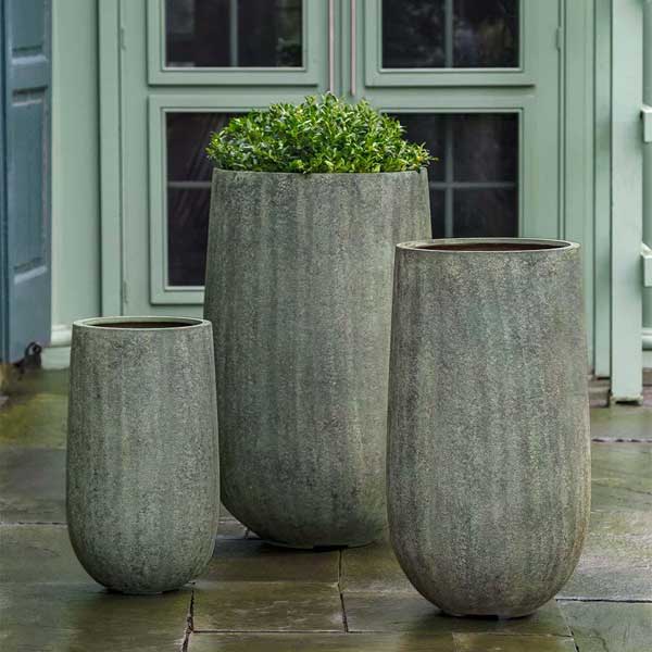 Mews Planter, Large - Verdigris Lite on concrete filled with plants