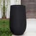 Campania International Mews Planter, Medium - Onyx Black Lite on concrete filled with plants