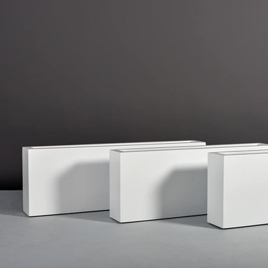 Miami Rectangle Fiberglass Planter on concrete shown with different sizes.