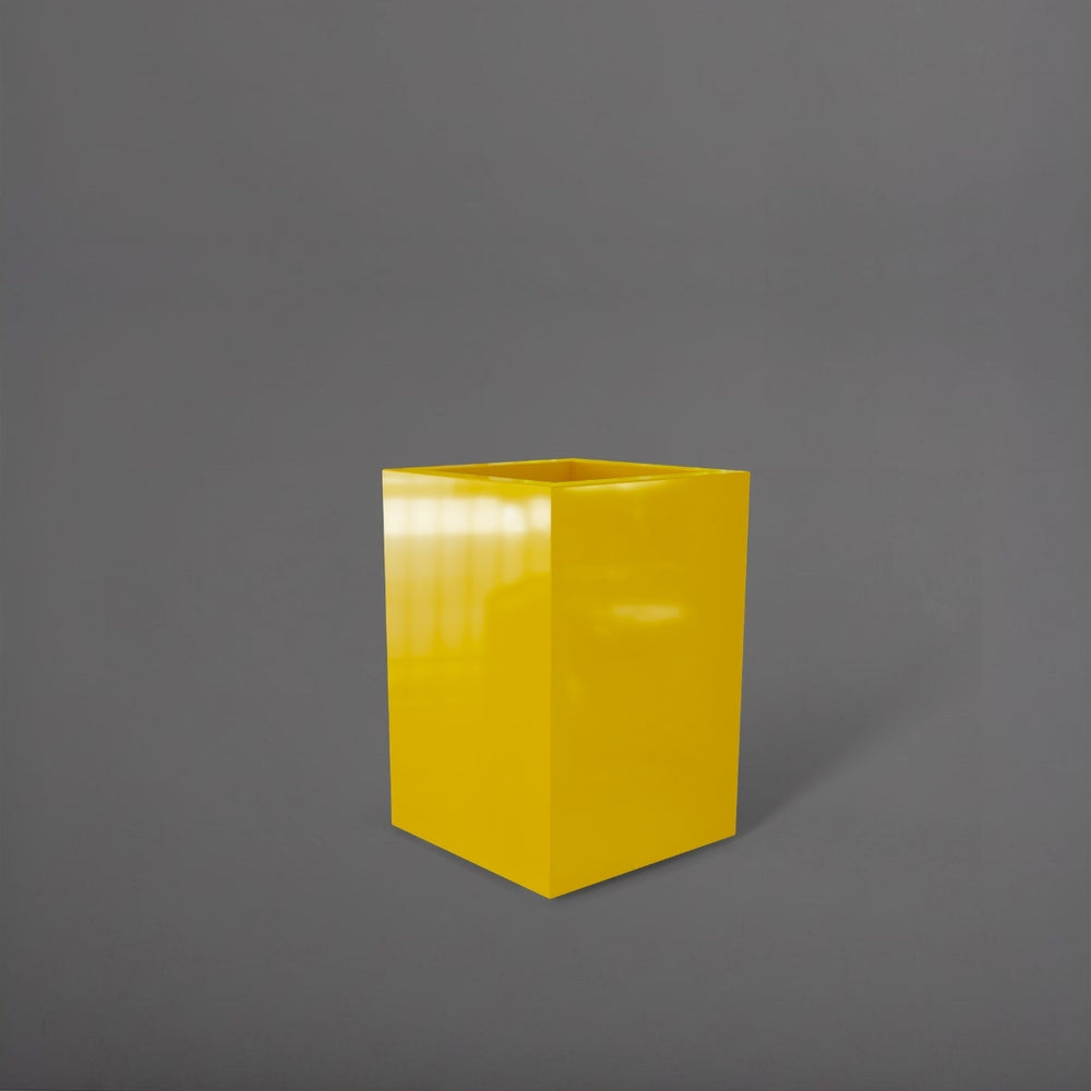 Miami Short Corner Fiberglass Planter in gloss saffron against gray background.