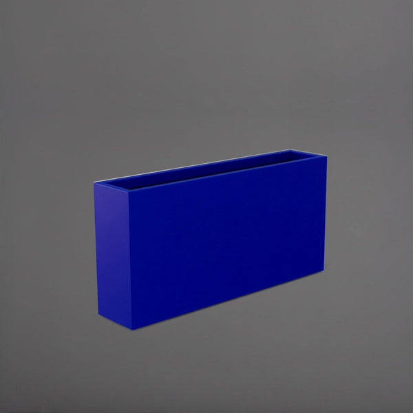 Milano Narrow Rectangle Planter in matte cobalt blue against gray background.