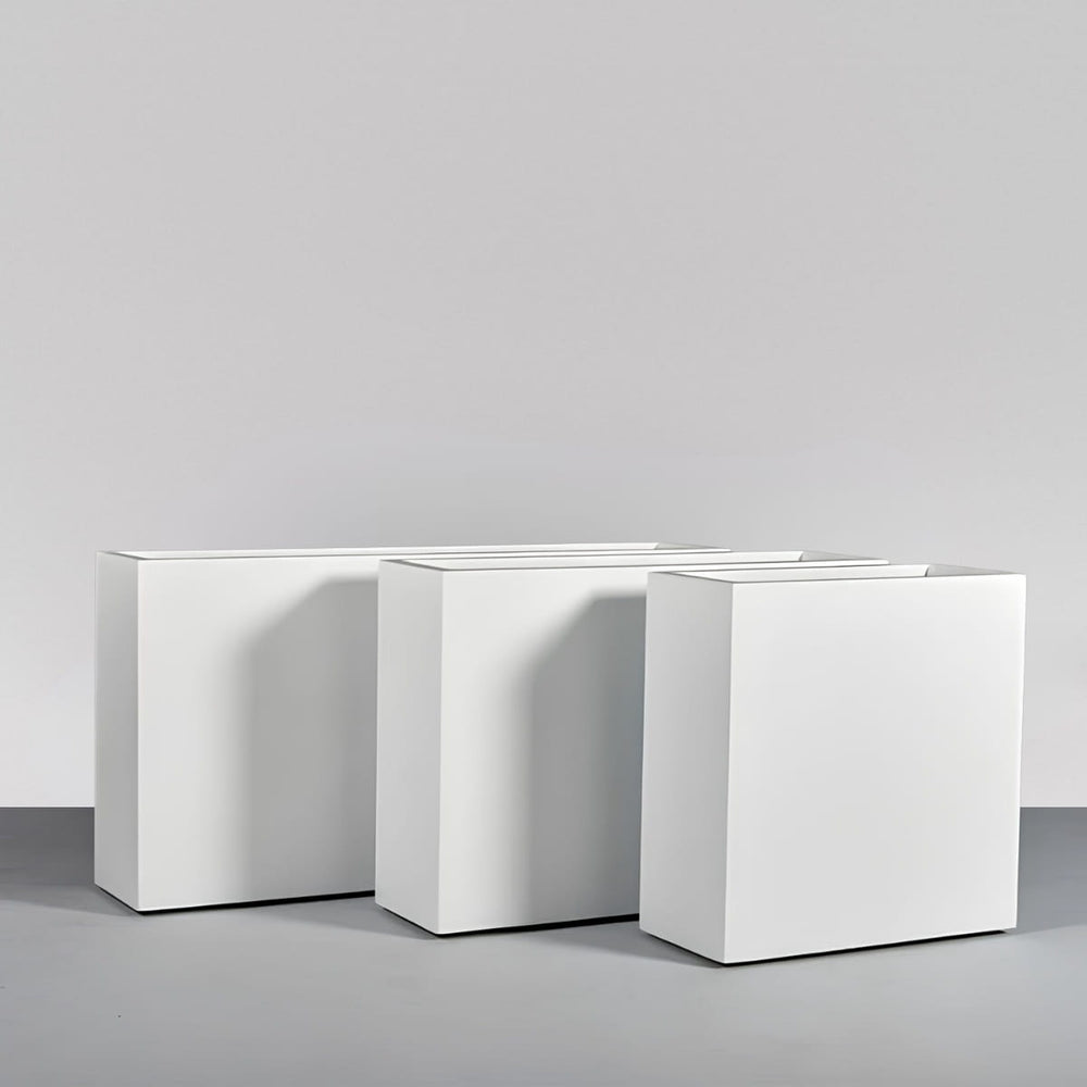 Milano Narrow Rectangle Planter on concrete against gray wall.