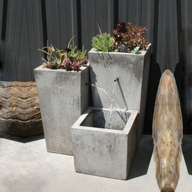 Moderno Fountain running filled with plants