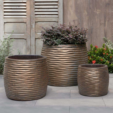 Montauk Planter, Tall - Bronze - S/3 on concrete filled with plants